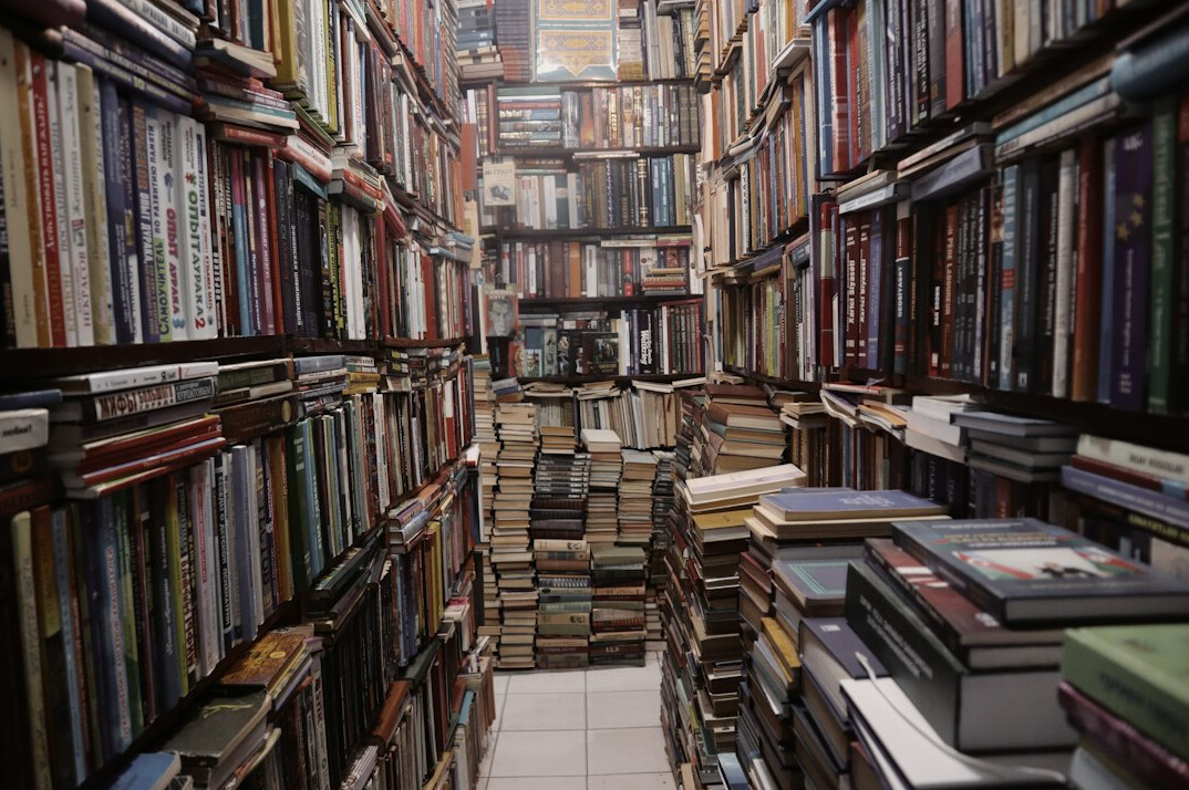 Wall of bookshelves filled with antique books