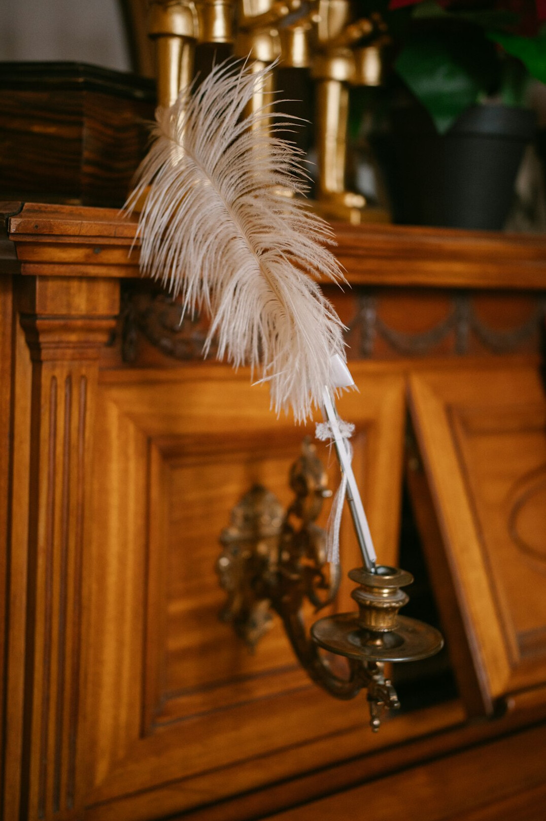 Old leather journal with a quill pen resting on an antique desk